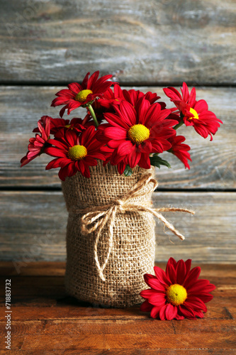 Fototapeta Naklejka Na Ścianę i Meble -  Beautiful chrysanthemum in vase on wooden background