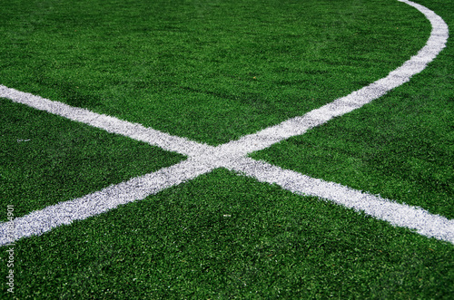 White abstract lines on a green football field.