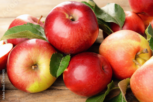 Ripe red apples on wooden background