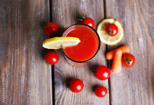 Glass of tomato juice with lemon and fresh tomatoes