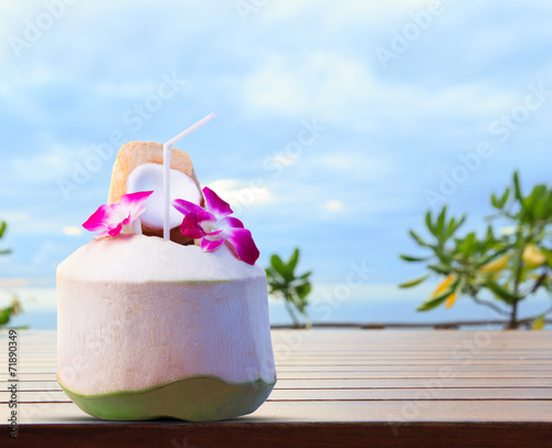 green coconut and orchid flowers as welcome drink in tropical de photo