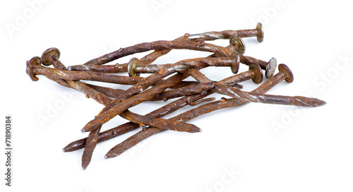 Macro of pile of rusty nails isolated against white