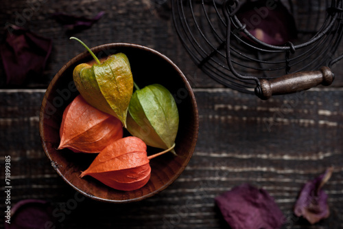 A wooden dish with a ground-cherry