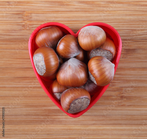 Hazelnuts in a heart bowl