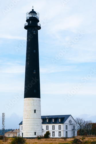 Lighthouse and visitor's house on Kuressaare island in Estonia photo