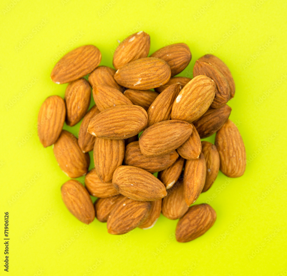 Fototapeta premium Almonds on green background