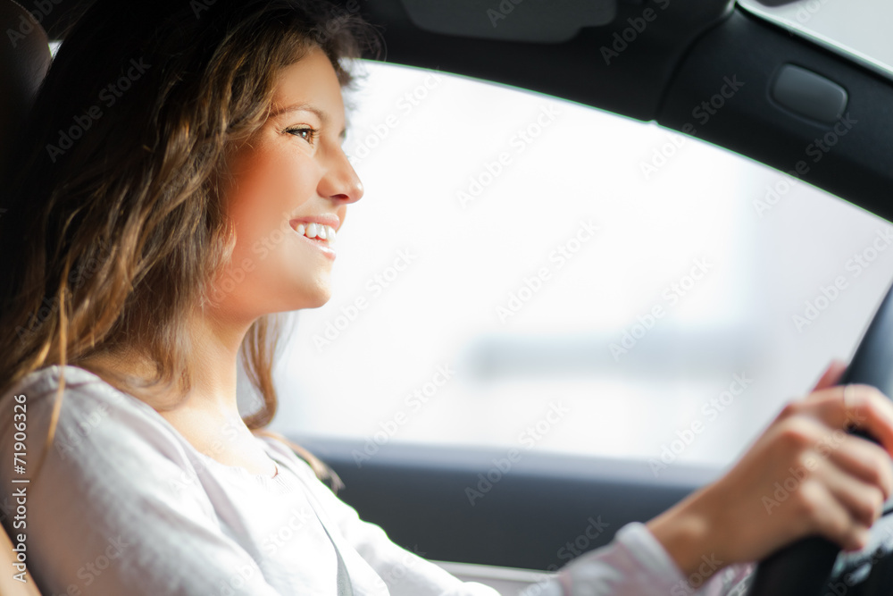 Beautiful young woman driving her car Beautiful young woman driving her car