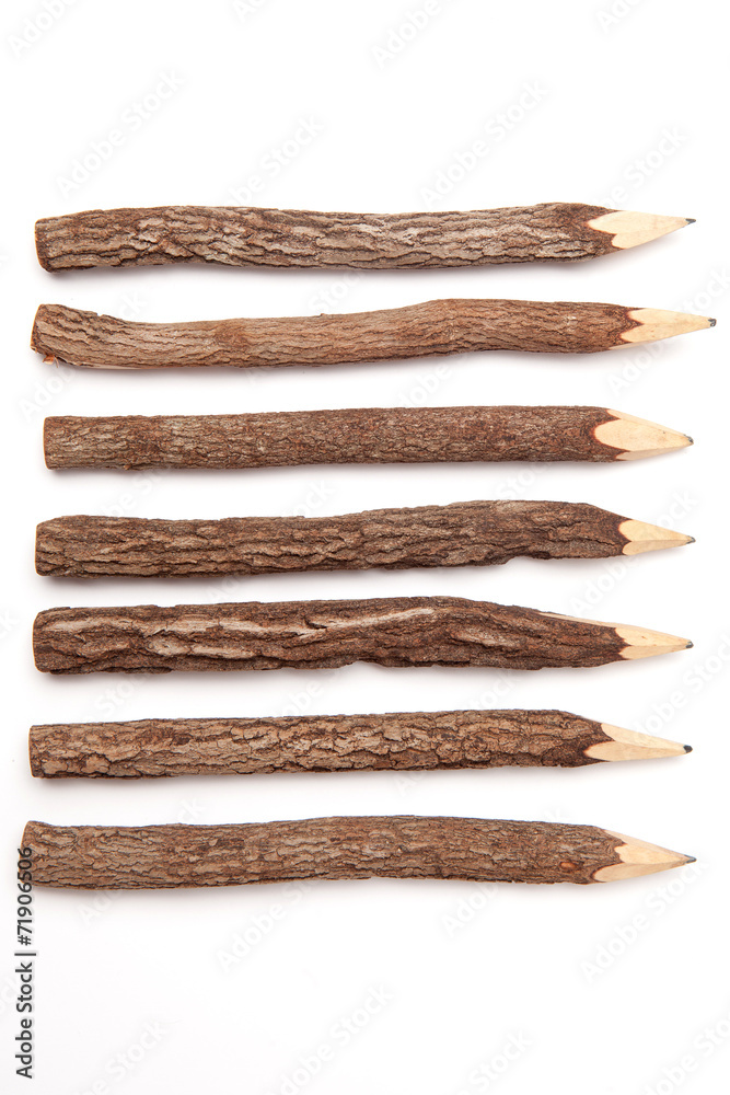 Wooden pencils made from tree branches isolated on white background Wooden pencils made from tree branches isolated on white background