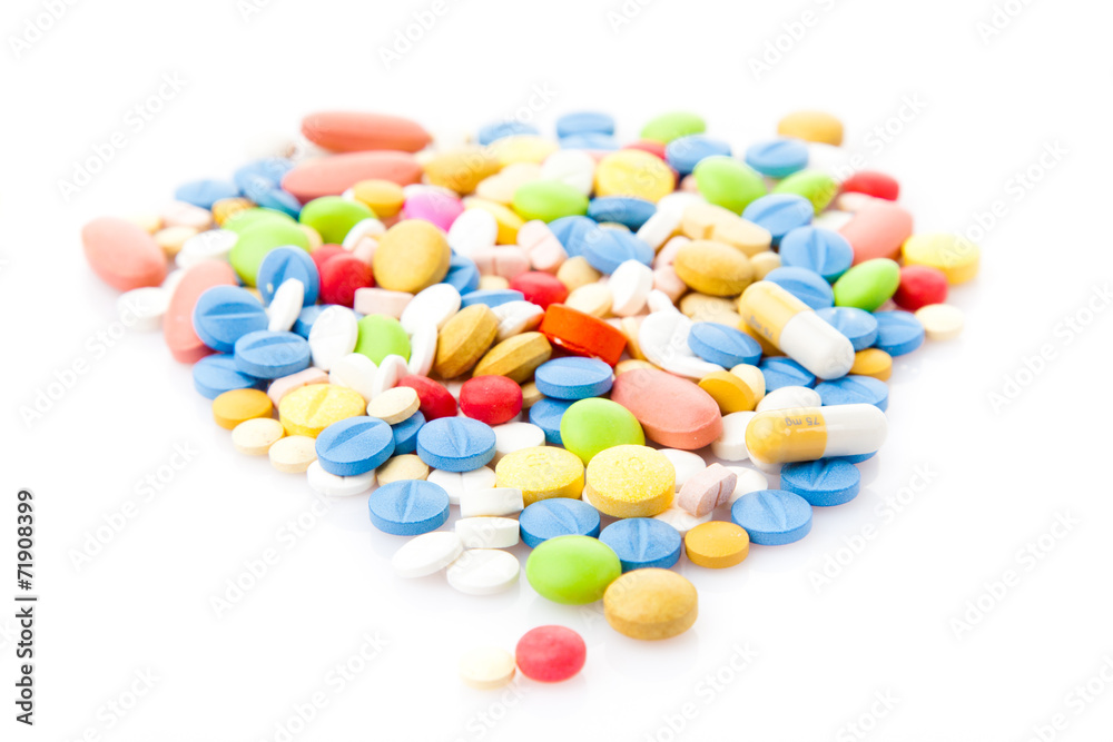 Pile of various colorful pills isolated on white Pile of various colorful pills isolated on white
