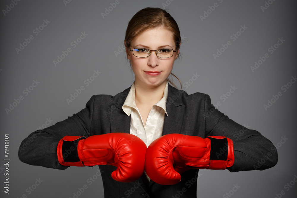 Businesswoman in red boxing gloves Businesswoman in red boxing gloves