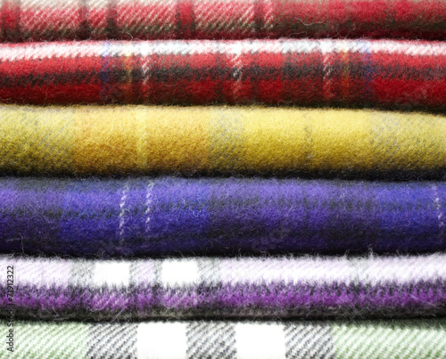 pure Scottish wool scarves stacked ready to be sold, many colors and an extraordinary softness