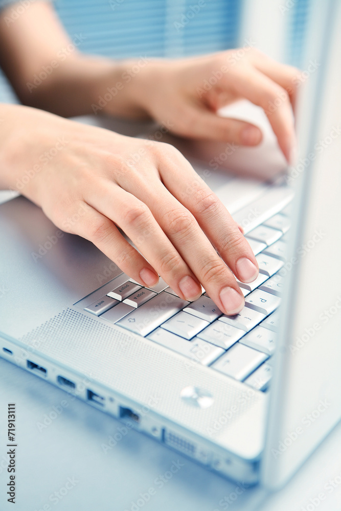 Silver keyboard and female hands. Working on a computer Silver keyboard and female hands. Working on a computer