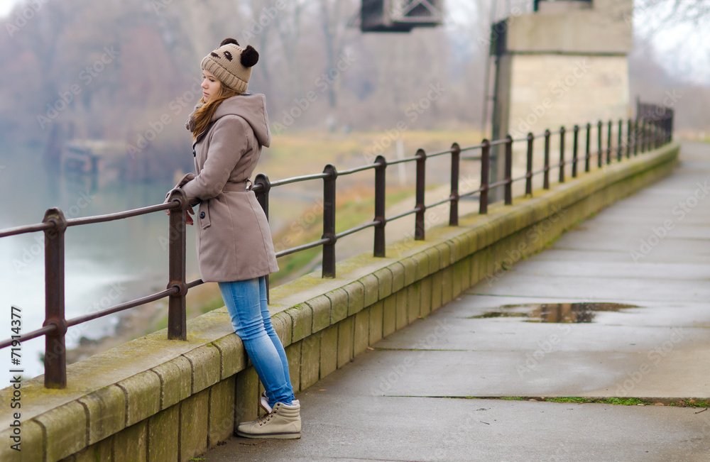 Sad teenage girl standing outside on cold winter day Sad teenage girl standing outside on cold winter day