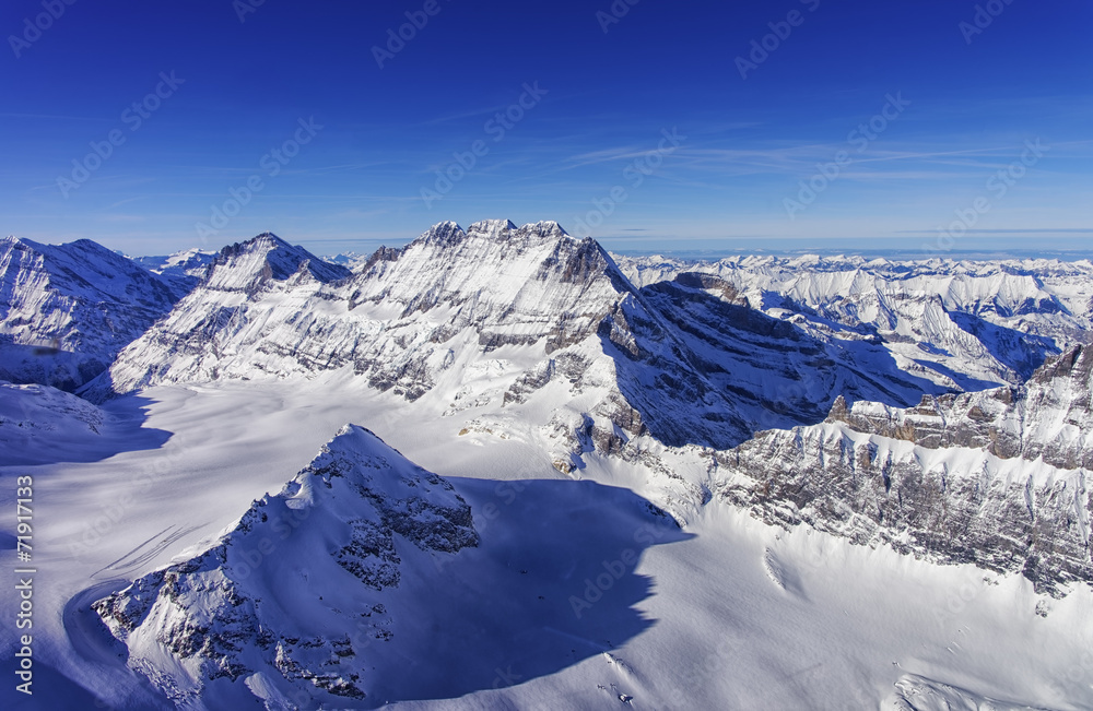 Mountain peaks chain in Jungfrau region helicopter view in winte