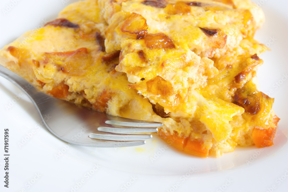 scrambled eggs with carrots and onions on a white plate