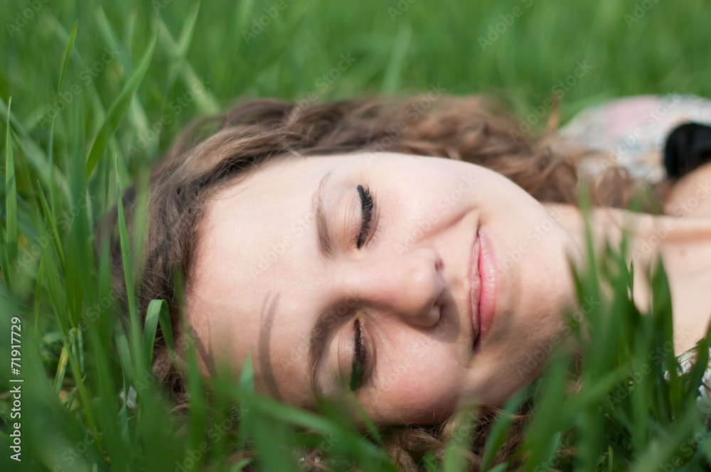 Woman relaxing outdoors looking happy and smiling Woman relaxing outdoors looking happy and smiling