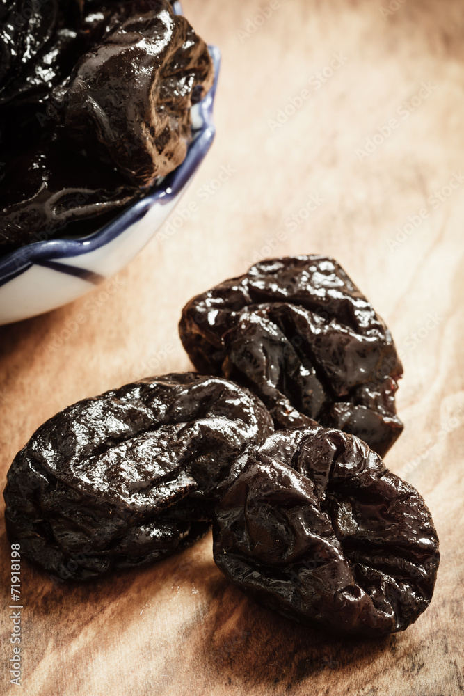 dried plums prunes on wooden table dried plums prunes on wooden table