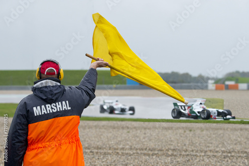 Marshal waving yellow flag photo