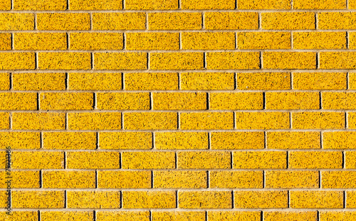 Energetic yellow brick wall as a background image with black vig