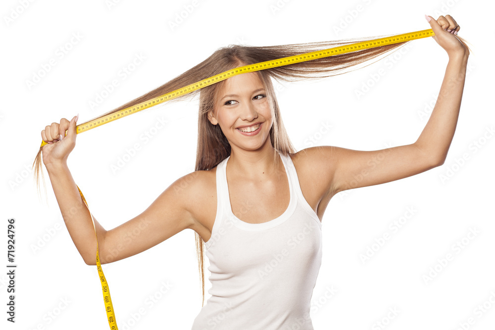 beautiful girl measured her hair with a measuring tape beautiful girl measured her hair with a measuring tape