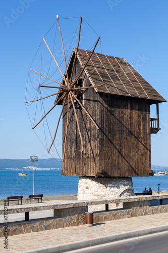 Old wooden windmill on the sea coast, the most popular landmark