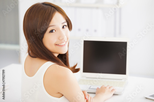 happy young asian woman using a laptop