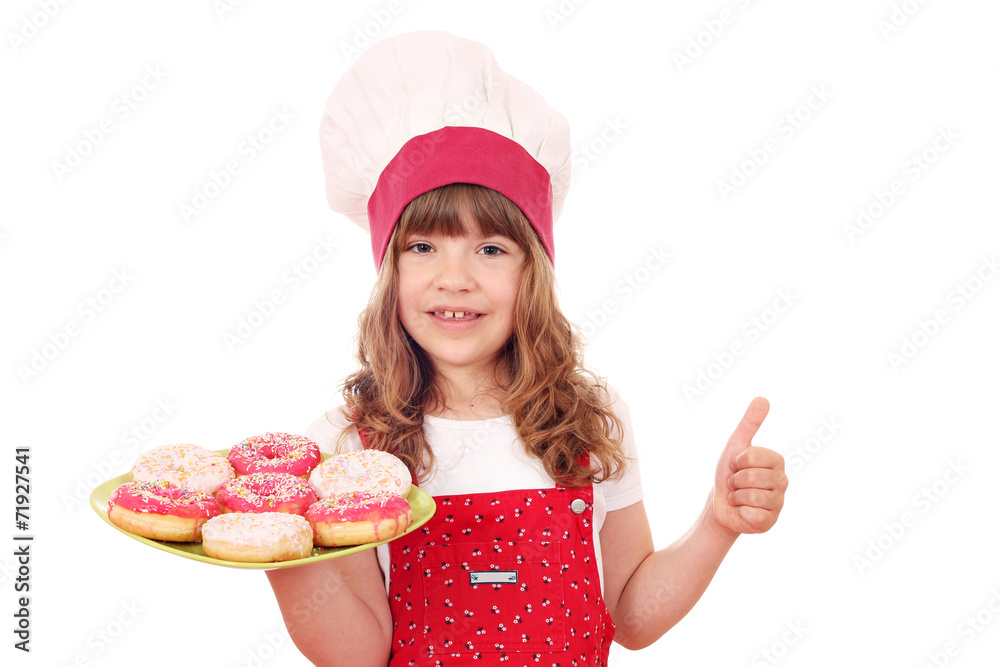 happy little girl cook with donuts and thumb up happy little girl cook with donuts and thumb up