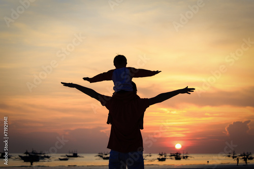 father and son having fun at sunset
