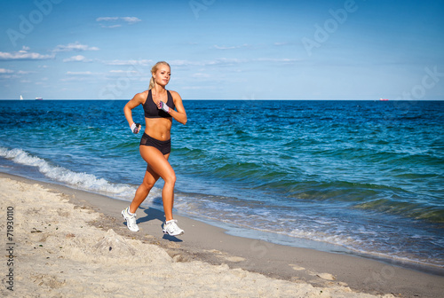 Running woman. Female runner jogging during outdoor workout on b