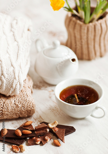 Cup of hot drink  knitting clothes  cinnamon and flowers. winter