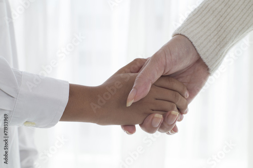 Hand of parent and child that handshake
