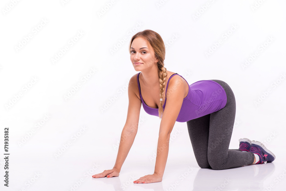 Healthy young sportswoman does the exercises Healthy young sportswoman does the exercises