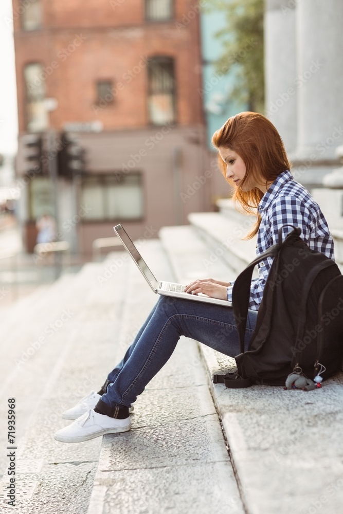 Young student using her laptop to study outside Young student using her laptop to study outside