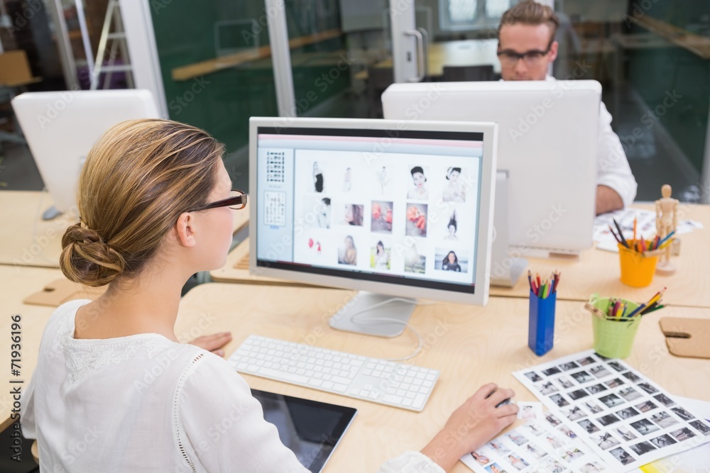 Photo editors using computers in office