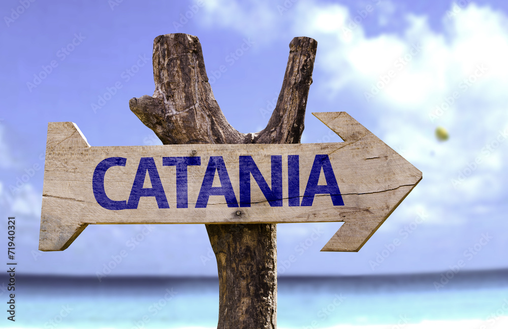 Catania wooden sign with a beach on background