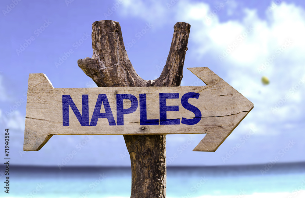 Naples wooden sign with a beach on background