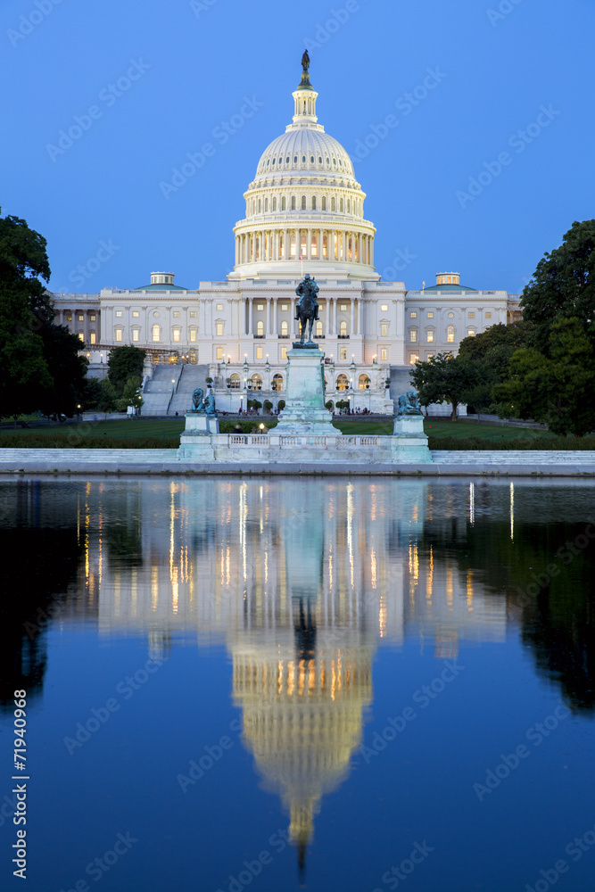 Capitol building in Washington illuminated at night.