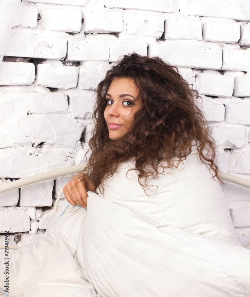 Obraz premium young woman under duvet