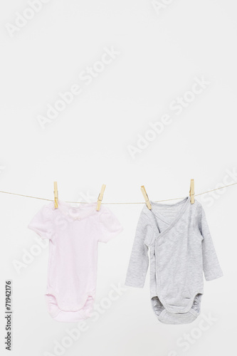 Pink and grey babygro on washing line