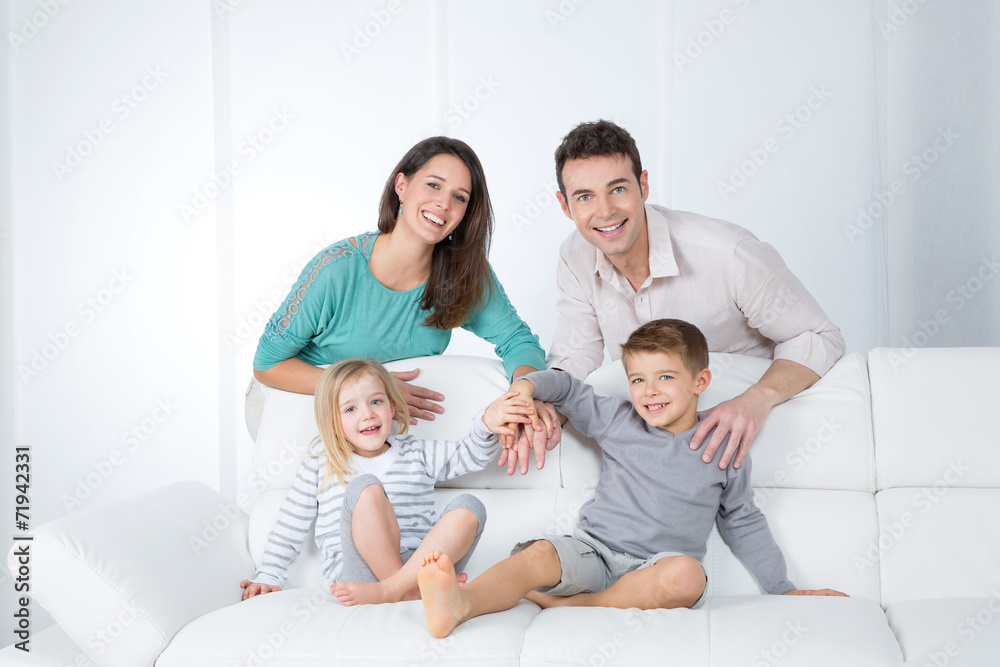 cheerful family on white sofa