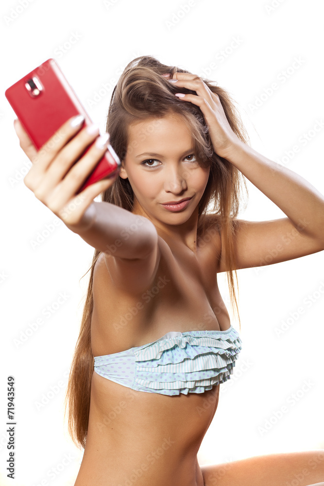 smiling young girl in bikini takes a selfie Stock Photo | Adobe Stock