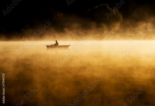 Early morning sunrise, boating on the lake in a huge fog