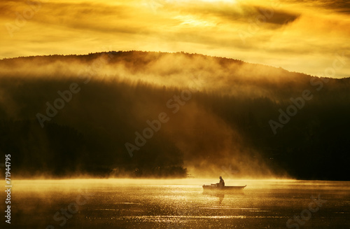 Early morning sunrise, boating on the lake in the sunlight