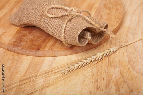 background of cutting boards and spikelet of wheat and sac