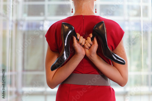 fit business woman in dress with two high heels