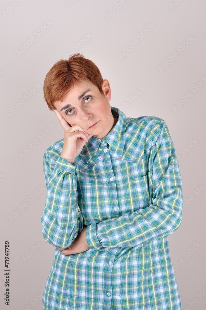 Thoughtful and sad woman with short hair leaning on the hand Thoughtful and sad woman with short hair leaning on the hand