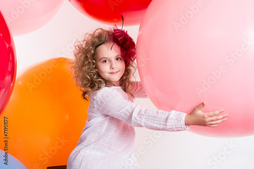 Happy cheerful girl on a big balls