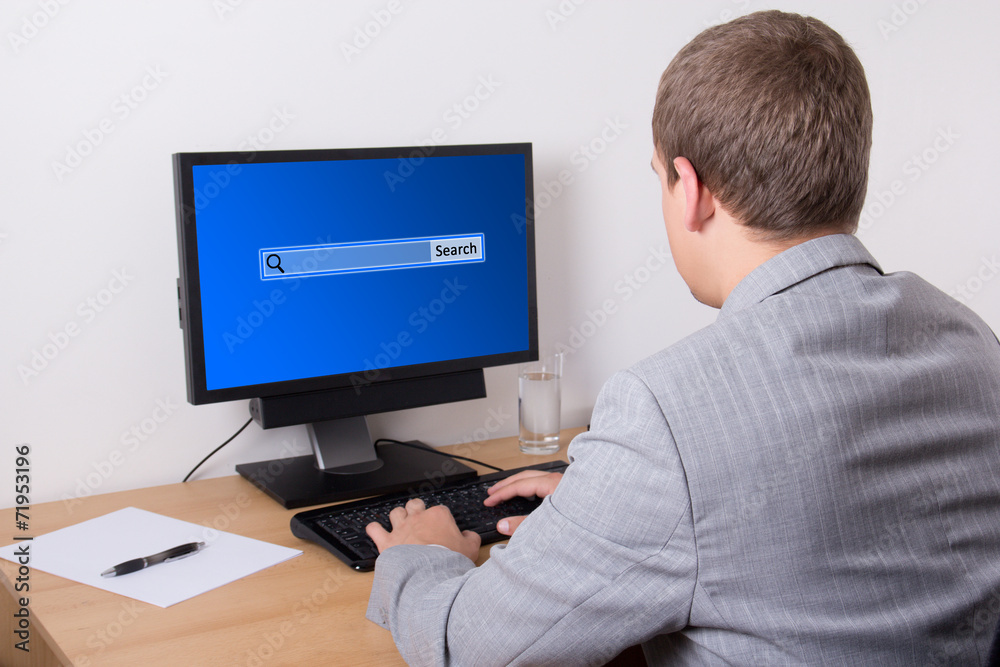 Fototapeta premium business man searching something in internet