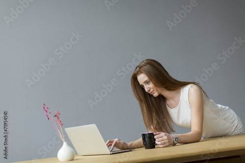 Young woman with laptop in ...