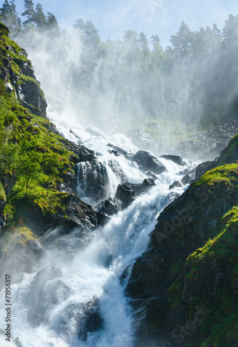 Summer Latefossen waterfall on mountain slope (Norway).